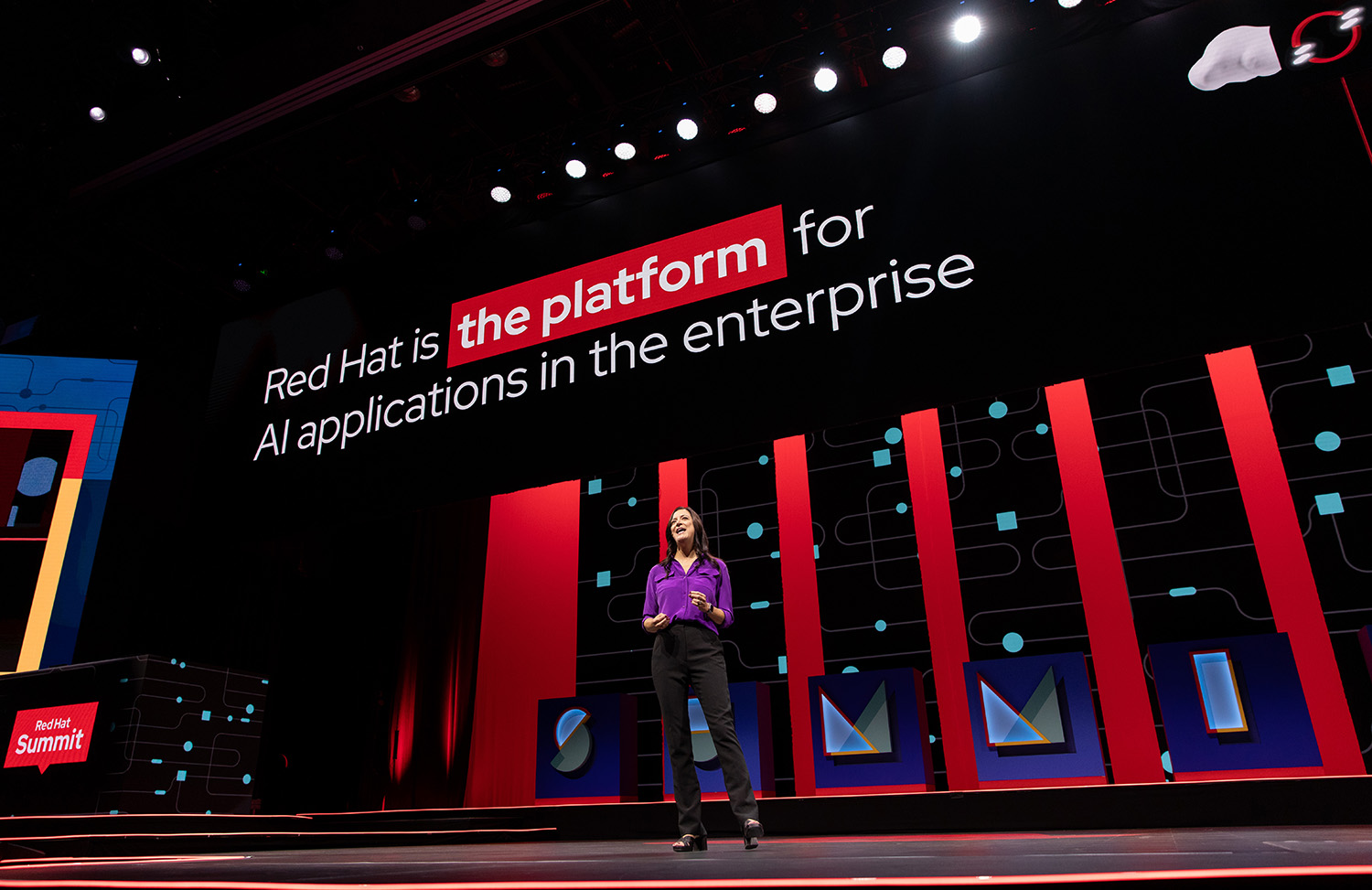 A photo shows Red Hat CMO Leigh Day presenting at Red Hat Summit.