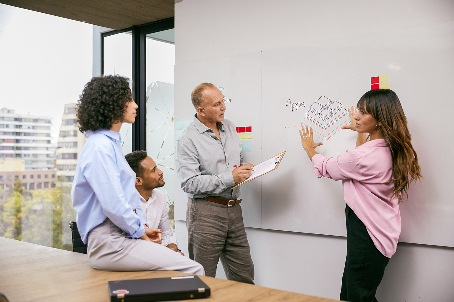 Three people collaborating with a whiteboard.