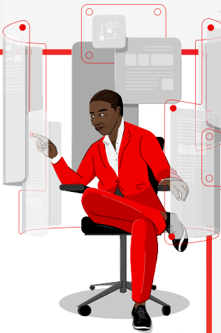 Person sitting with leg crossed working on multiple computers/devices